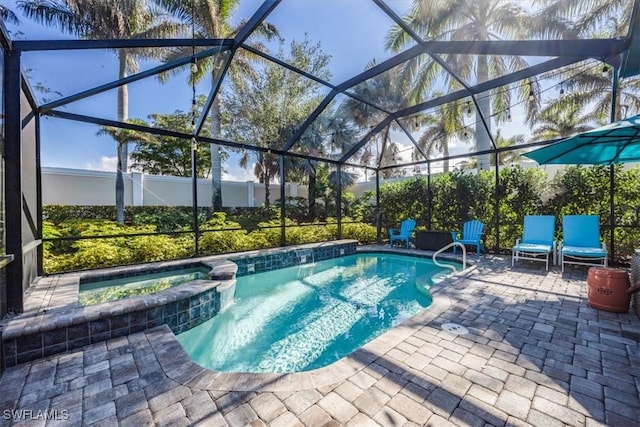 view of swimming pool featuring glass enclosure, an in ground hot tub, and a patio