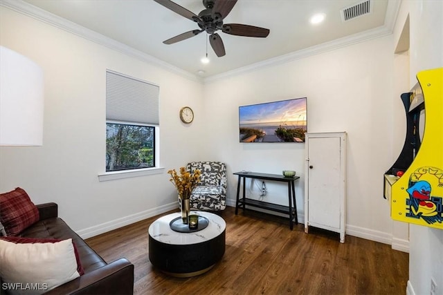 living area featuring dark hardwood / wood-style floors, ceiling fan, and crown molding