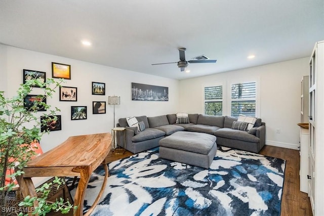 living room featuring ceiling fan and dark wood-type flooring