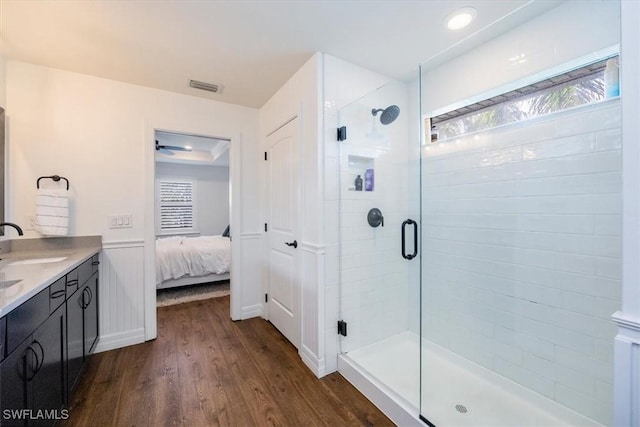 bathroom with ceiling fan, vanity, wood-type flooring, and an enclosed shower