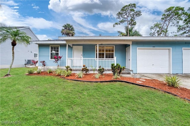 ranch-style house with covered porch, a front yard, and a garage