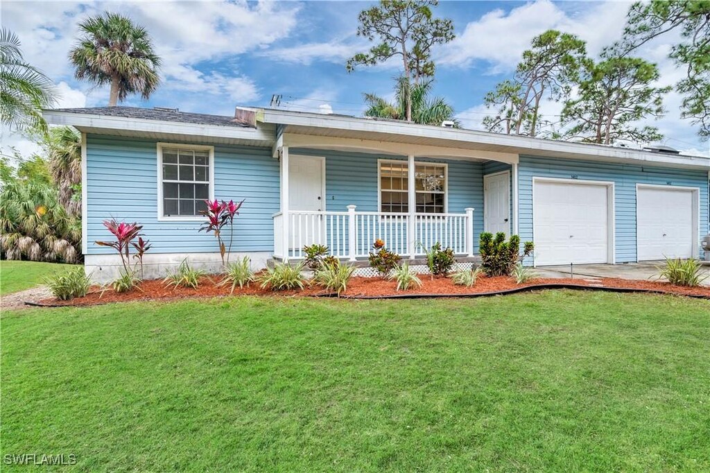 1482 La Petite Ct, Naples, FL 34104 - ranch-style home with covered porch, a garage, and a front yard