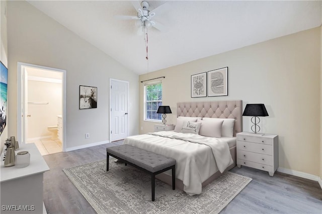 bedroom featuring ceiling fan, light wood-type flooring, ensuite bathroom, and high vaulted ceiling