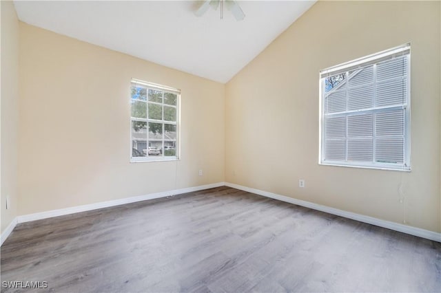 unfurnished room with vaulted ceiling, light hardwood / wood-style flooring, and ceiling fan