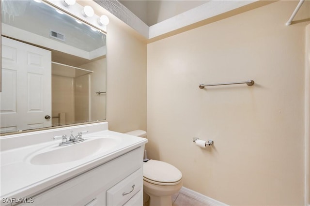 bathroom with walk in shower, vanity, and toilet