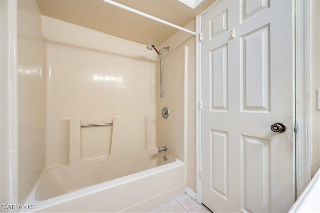 bathroom with tile patterned floors and shower / tub combination