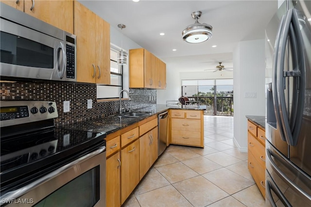 kitchen with ceiling fan, hanging light fixtures, stainless steel appliances, kitchen peninsula, and light tile patterned floors