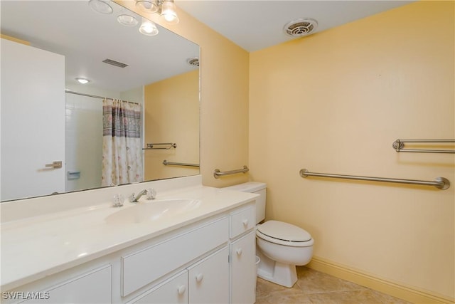 bathroom featuring tile patterned floors, vanity, curtained shower, and toilet