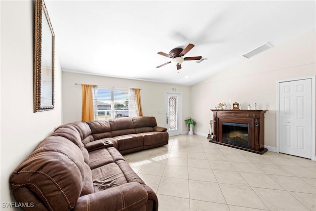 living room with ceiling fan, light tile patterned floors, and vaulted ceiling