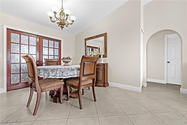 dining room with vaulted ceiling, a notable chandelier, and light tile patterned flooring