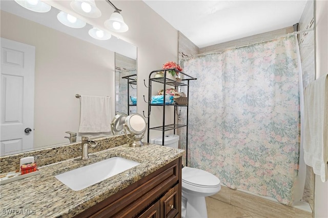 bathroom with tile patterned floors, a shower with curtain, vanity, and toilet