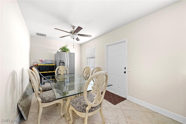 dining area with ceiling fan and light tile patterned flooring