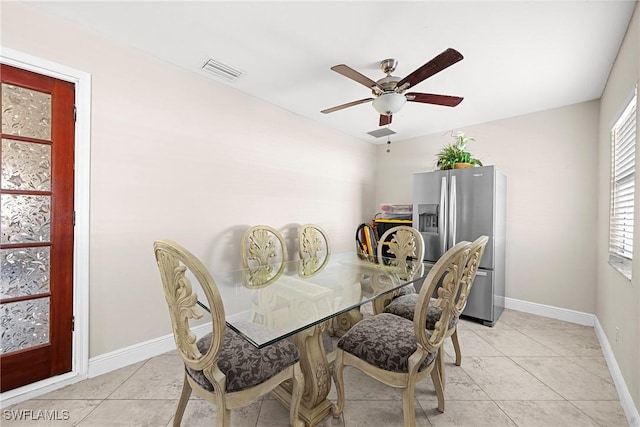 dining area with ceiling fan, light tile patterned flooring, and a healthy amount of sunlight