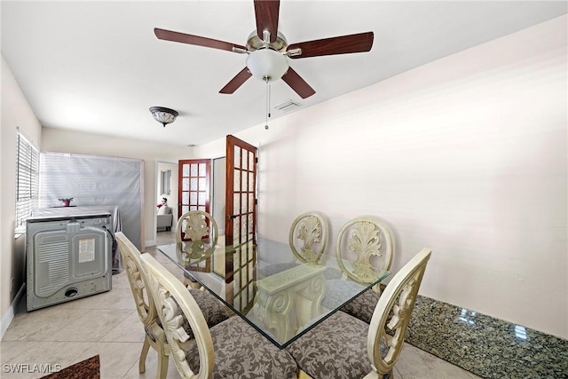 tiled dining room featuring french doors, a wealth of natural light, and ceiling fan