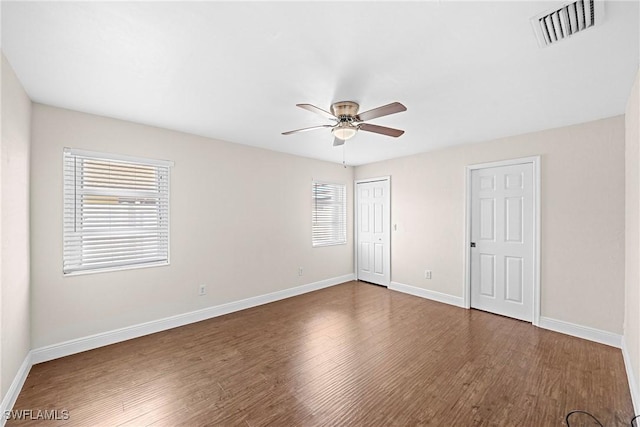 unfurnished bedroom featuring ceiling fan and dark wood-type flooring