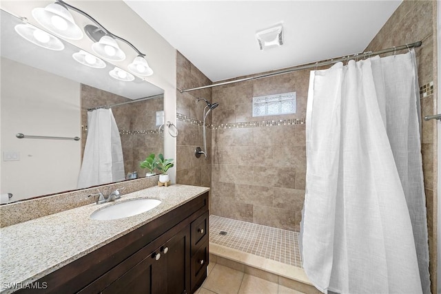 bathroom with tile patterned floors, curtained shower, and vanity