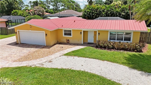 single story home featuring a front yard and a garage