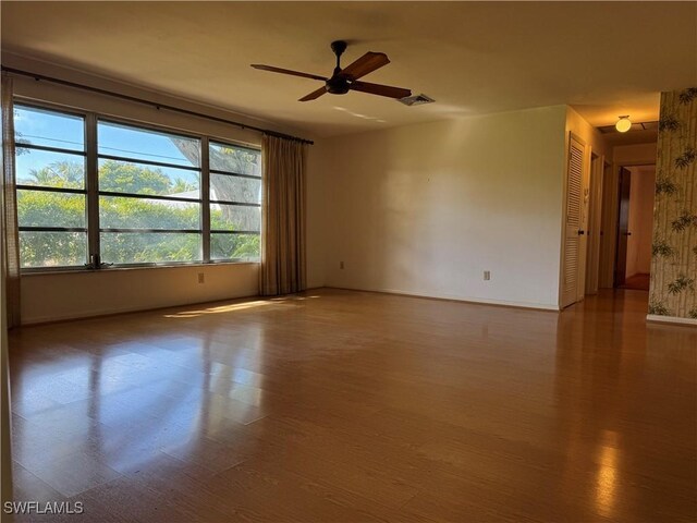 unfurnished room featuring hardwood / wood-style floors and ceiling fan