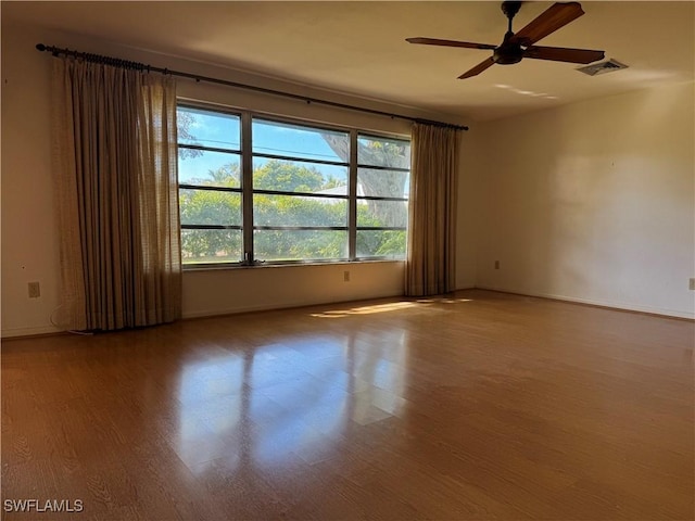 spare room featuring wood-type flooring and ceiling fan