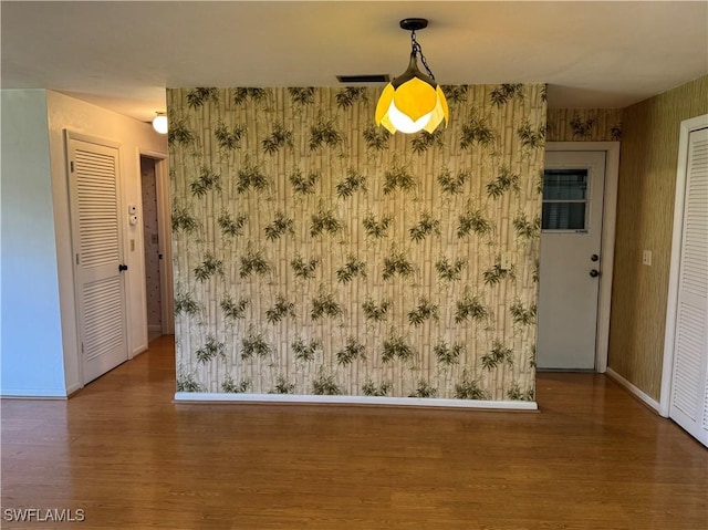 unfurnished dining area featuring hardwood / wood-style flooring