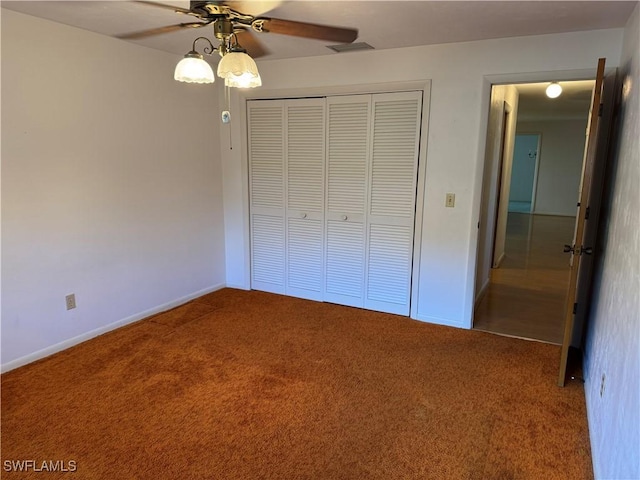 unfurnished bedroom with carpet flooring, ceiling fan, and a closet