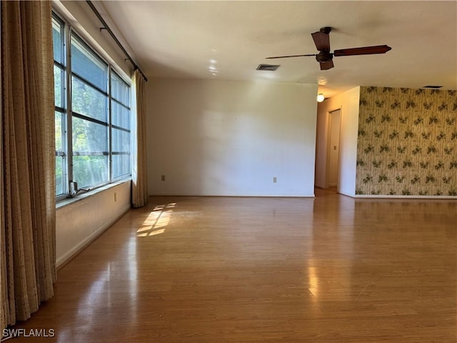 spare room featuring light hardwood / wood-style floors and ceiling fan