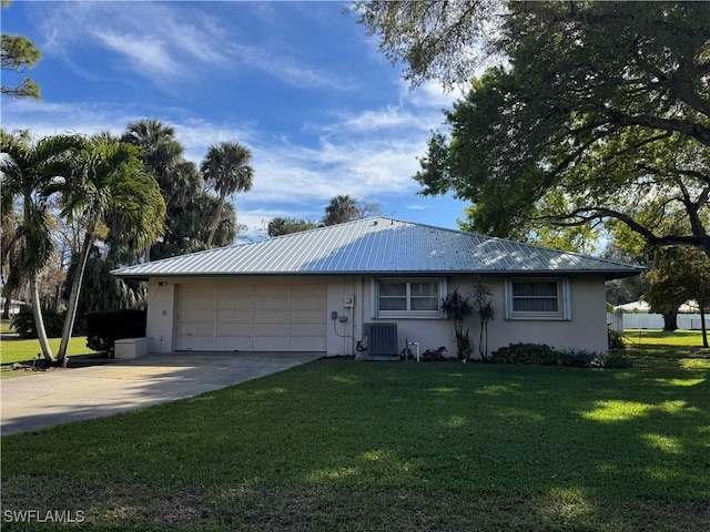 ranch-style home with cooling unit, a garage, and a front lawn