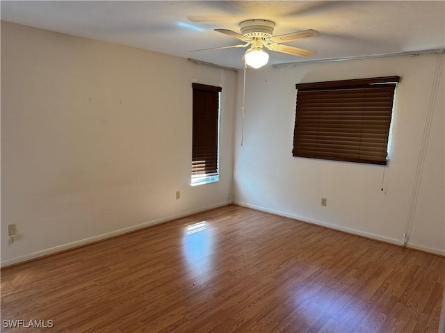 unfurnished room with ceiling fan and wood-type flooring