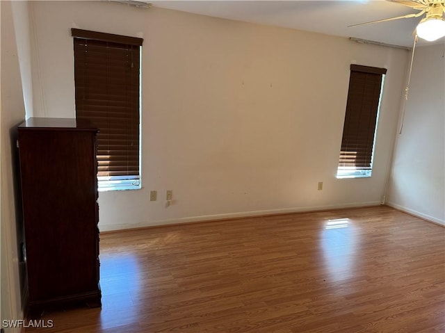 spare room featuring hardwood / wood-style flooring and ceiling fan