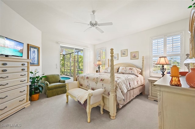 bedroom with access to outside, multiple windows, ceiling fan, and light carpet