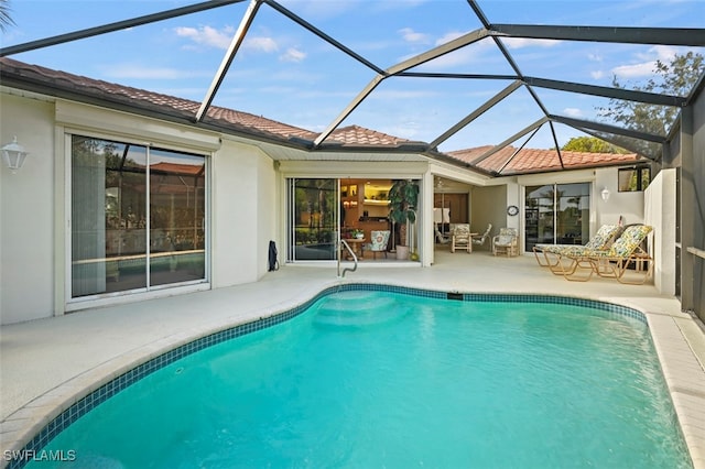 view of swimming pool with a patio and glass enclosure