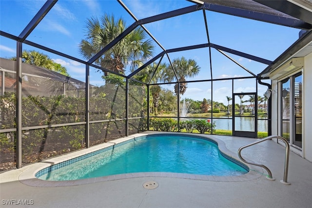 view of swimming pool with glass enclosure and a water view