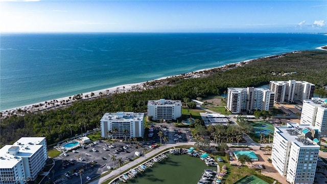 birds eye view of property with a water view and a view of the beach