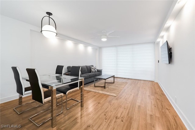 dining space featuring ceiling fan and hardwood / wood-style floors