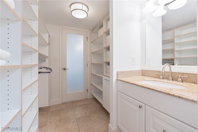 bathroom featuring tile patterned flooring and vanity