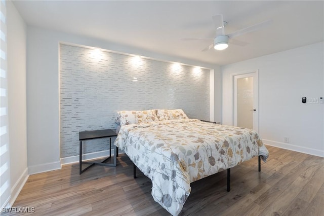 bedroom with hardwood / wood-style floors and ceiling fan