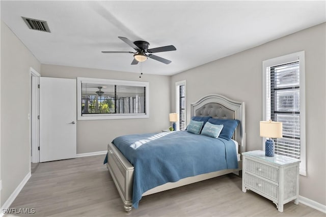 bedroom with ceiling fan and light wood-type flooring