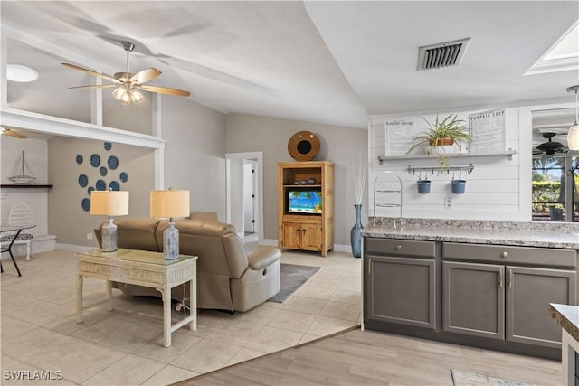 living room featuring light wood-type flooring, vaulted ceiling, and ceiling fan