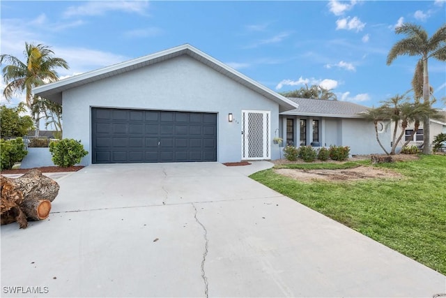 ranch-style house featuring a garage and a front yard