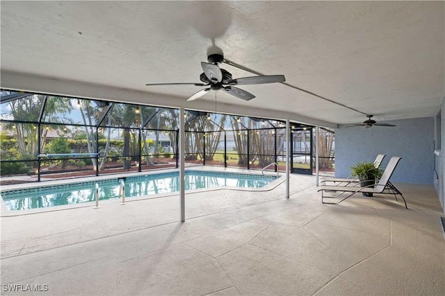 view of pool with a patio and glass enclosure