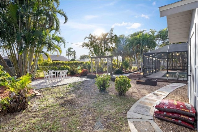 view of yard featuring a patio area, a lanai, and a swimming pool