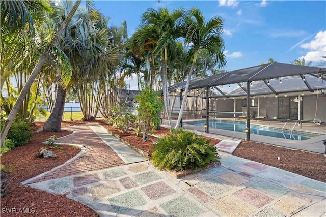 view of swimming pool featuring a lanai