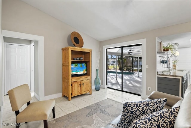 tiled living room featuring ceiling fan and lofted ceiling