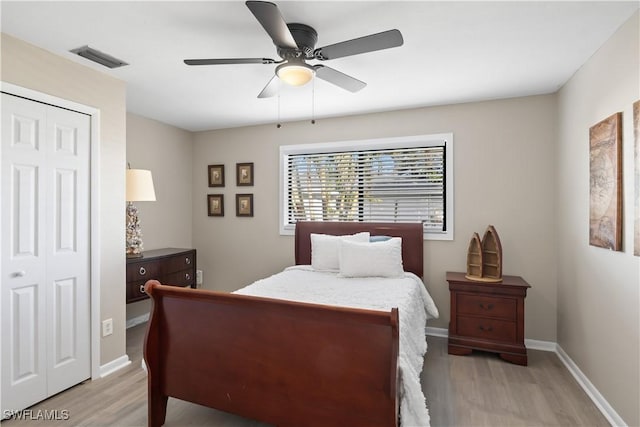 bedroom with ceiling fan, a closet, and light hardwood / wood-style floors