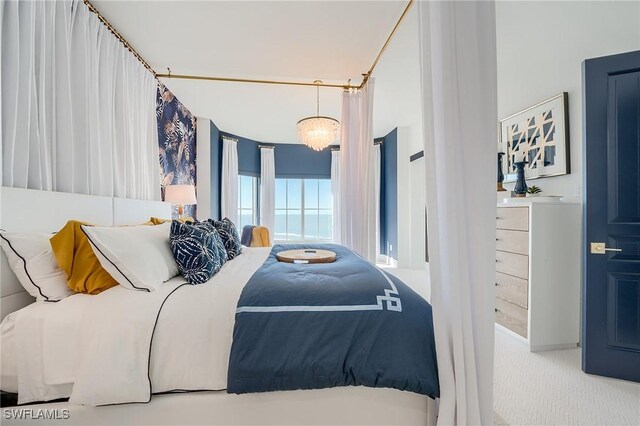 carpeted bedroom with a chandelier