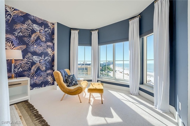 sitting room with carpet flooring and a water view