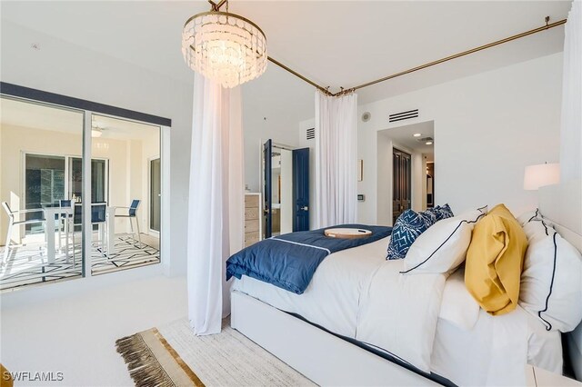 carpeted bedroom featuring a notable chandelier