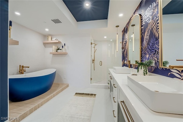 bathroom with shower with separate bathtub, vanity, and a raised ceiling