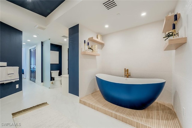 bathroom with a bathing tub and toilet