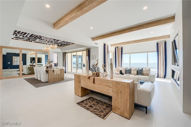 living room featuring beam ceiling and an inviting chandelier